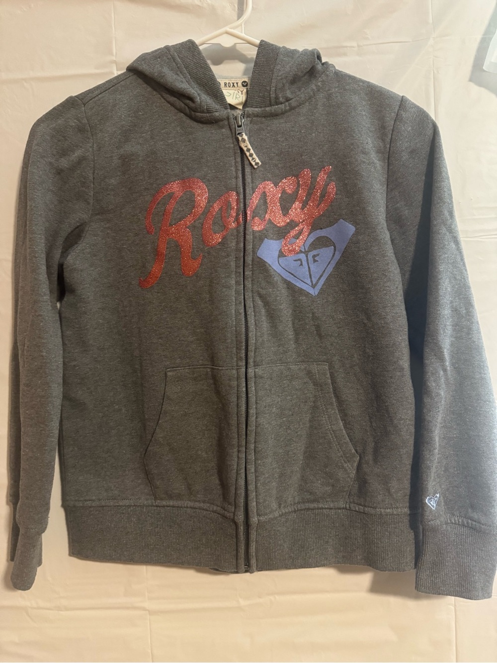 Roxy Girls' Dark Gray Zip Hoodie with Red Glitter Logo and Blue Emblem
